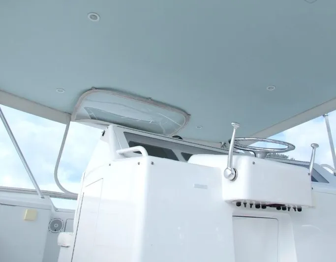  Yacht Photos Pics 1999 Viking Boats Convertible helm station with steering wheel and controls.