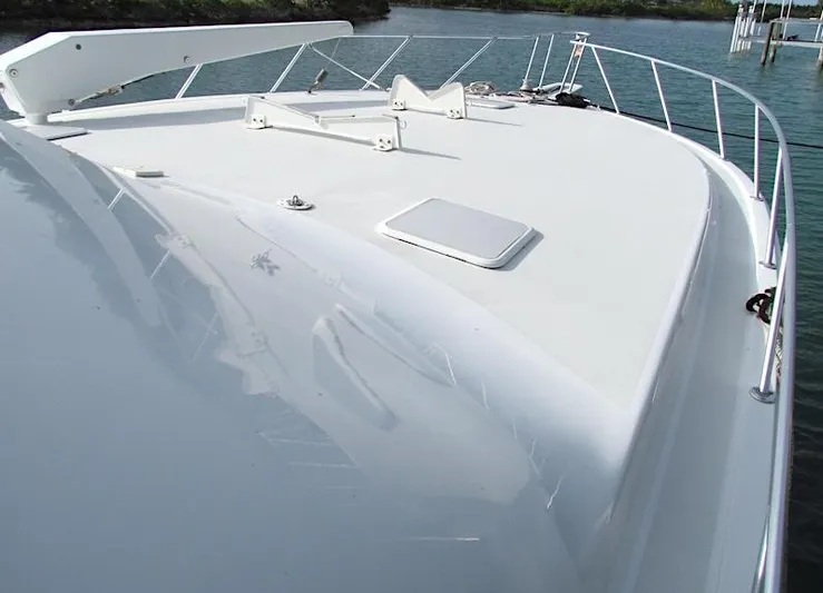  Yacht Photos Pics 1999 Viking Boats Convertible yacht deck with sleek white finish and railing.