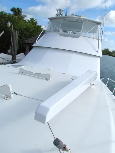  Yacht Photos Pics 1999 Viking Boats Convertible on water, showcasing sleek design and spacious deck.