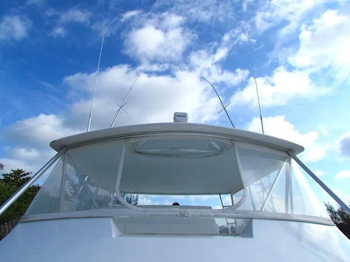  Yacht Photos Pics 1999 Viking Boats Convertible against a bright blue sky with clouds.