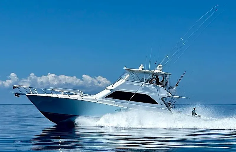  Yacht Photos Pics 1999 Viking Boats Convertible cruising on calm ocean waters under a clear blue sky.