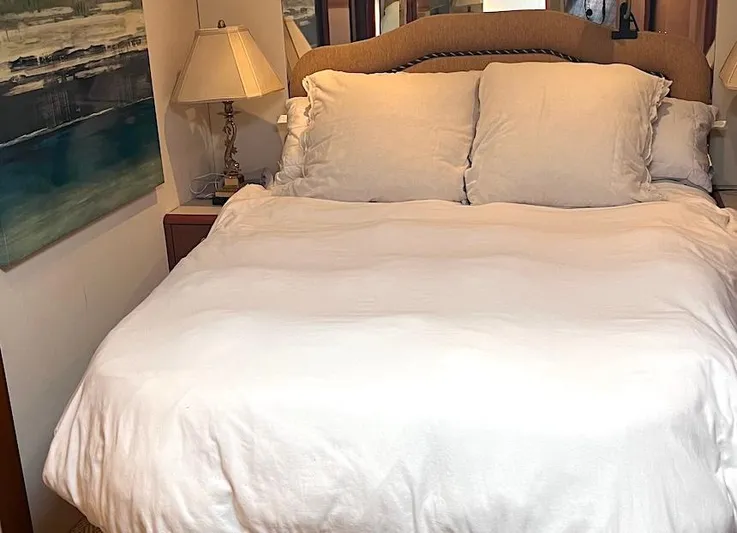  Yacht Photos Pics Cozy bedroom interior on 1999 Viking Boats Convertible, featuring a plush bed and elegant decor.