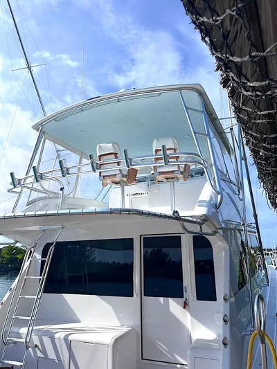  Yacht Photos Pics 1999 Viking Boats Convertible yacht docked, featuring a spacious upper deck and sleek design.