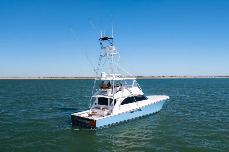 Emeritus Yacht Photos Pics 2001 Viking 61 Convertible yacht cruising on open water under clear blue skies.