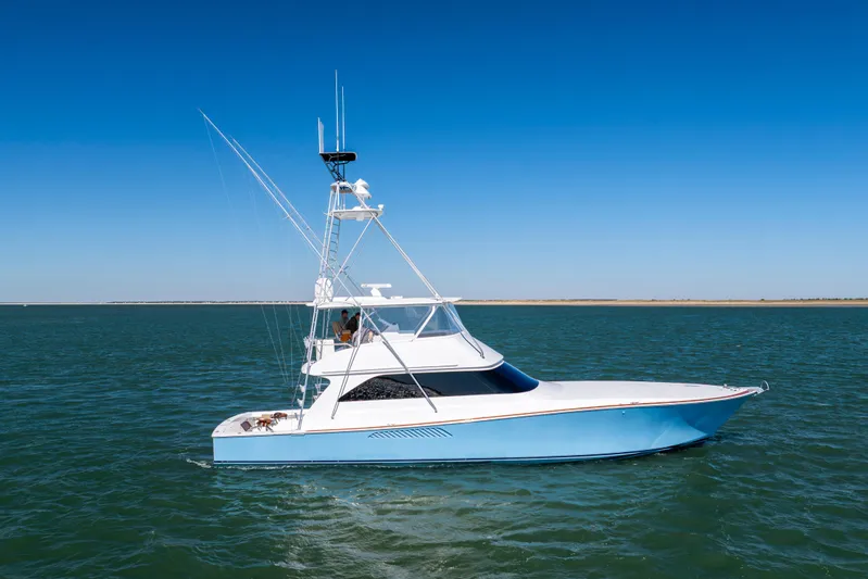 Emeritus Yacht Photos Pics 2001 Viking 61 Convertible yacht cruising on open water under clear blue sky.