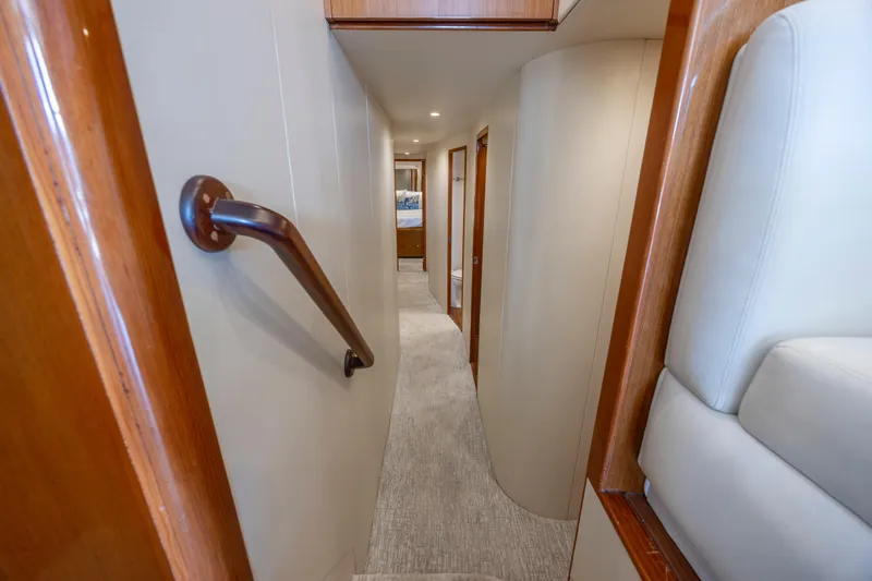 Emeritus Yacht Photos Pics Interior hallway of 2001 Viking 61 Convertible yacht, featuring wood accents and modern design.
