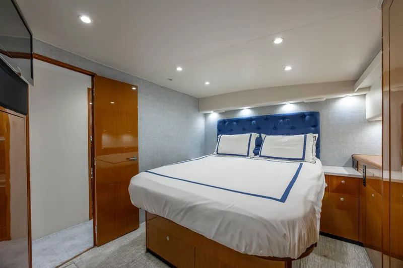Emeritus Yacht Photos Pics Luxurious bedroom interior of 2001 Viking 61 Convertible yacht with elegant bedding and lighting.