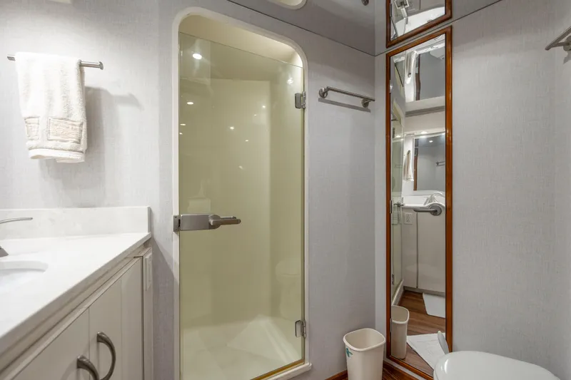 Emeritus Yacht Photos Pics Bathroom interior of 2001 Viking 61 Convertible yacht with shower and mirror.