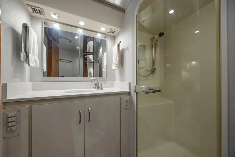 Emeritus Yacht Photos Pics Bathroom interior of 2001 Viking 61 Convertible yacht with shower and vanity.