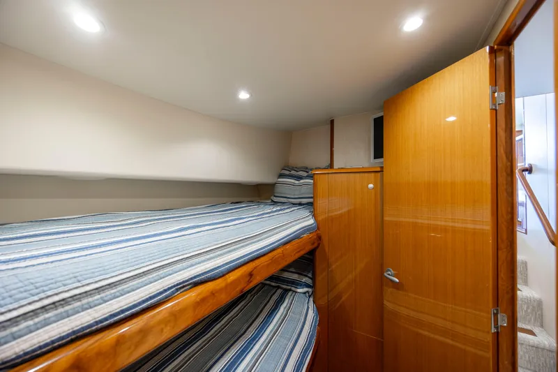 Emeritus Yacht Photos Pics Cozy bunk beds in 2001 Viking 61 Convertible yacht cabin with wooden finishes.