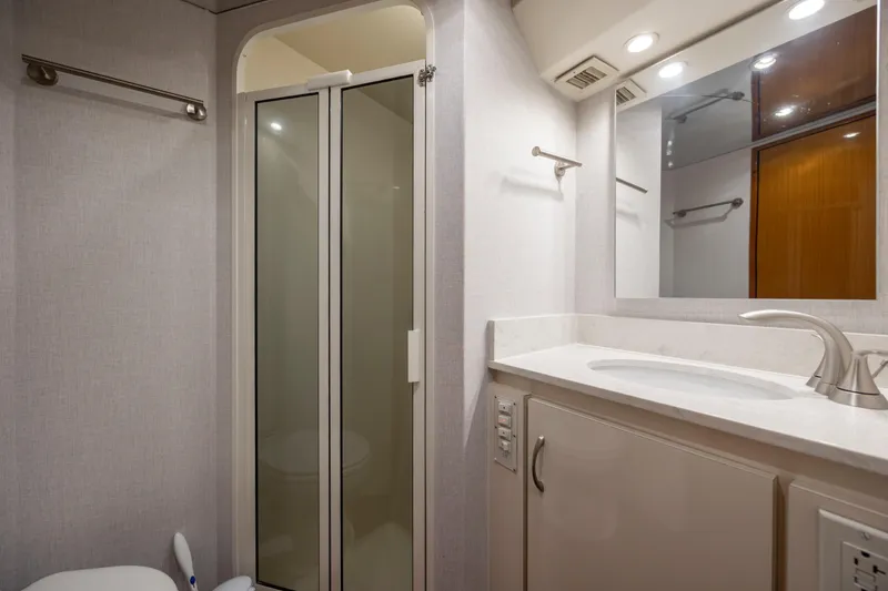 Emeritus Yacht Photos Pics Luxurious bathroom in 2001 Viking 61 Convertible yacht with modern fixtures and shower.