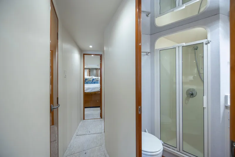 Emeritus Yacht Photos Pics Hallway view inside 2001 Viking 61 Convertible yacht, featuring a bathroom and bedroom.