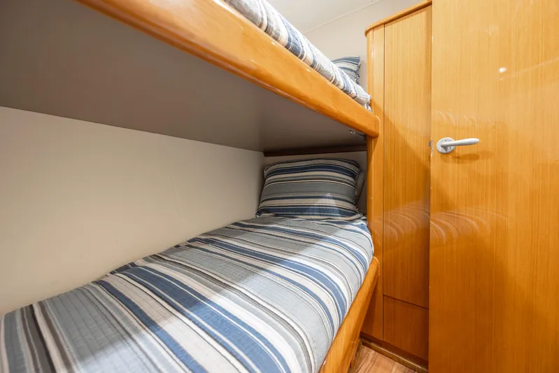 Emeritus Yacht Photos Pics Bunk beds in 2001 Viking 61 Convertible yacht cabin with striped bedding.