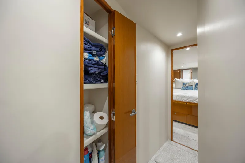 Emeritus Yacht Photos Pics Linen closet and bedroom view inside 2001 Viking 61 Convertible yacht.