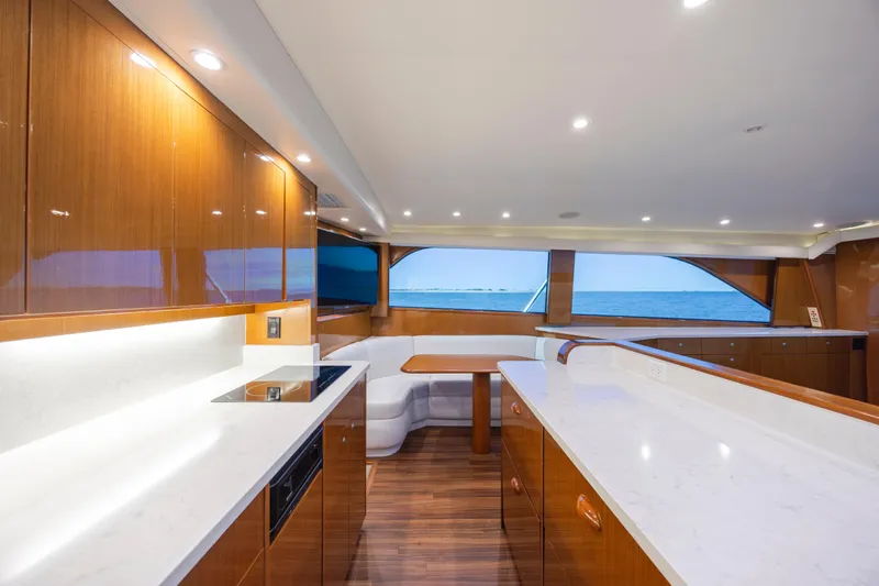 Emeritus Yacht Photos Pics Luxurious interior of a 2001 Viking 61 Convertible yacht with modern kitchen and ocean view.