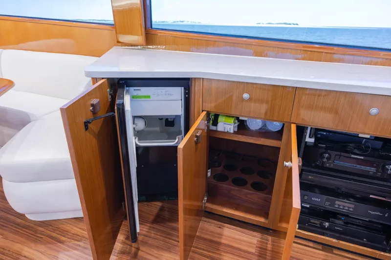 Emeritus Yacht Photos Pics Interior of 2001 Viking 61 Convertible yacht with open cabinets and appliances.