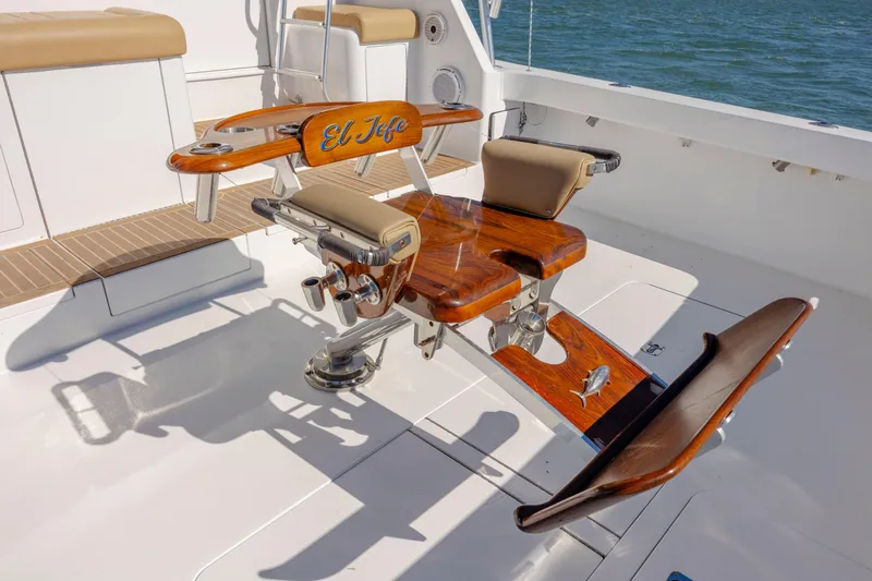 Emeritus Yacht Photos Pics Fishing chair on 2001 Viking 61 Convertible yacht deck, labeled "El Jefe," with ocean backdrop.