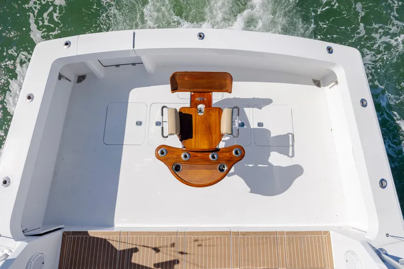 Emeritus Yacht Photos Pics 2001 Viking 61 Convertible yacht deck with fishing chair, surrounded by ocean waves.