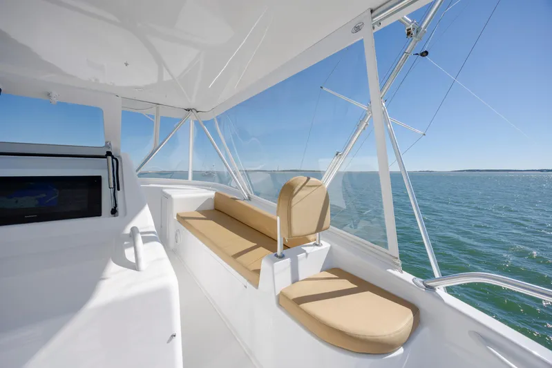 Emeritus Yacht Photos Pics Interior view of 2001 Viking 61 Convertible yacht with beige seating and ocean backdrop.