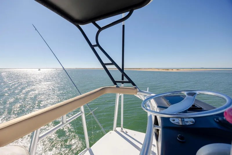 Emeritus Yacht Photos Pics 2001 Viking 61 Convertible yacht helm with ocean view and clear blue sky.