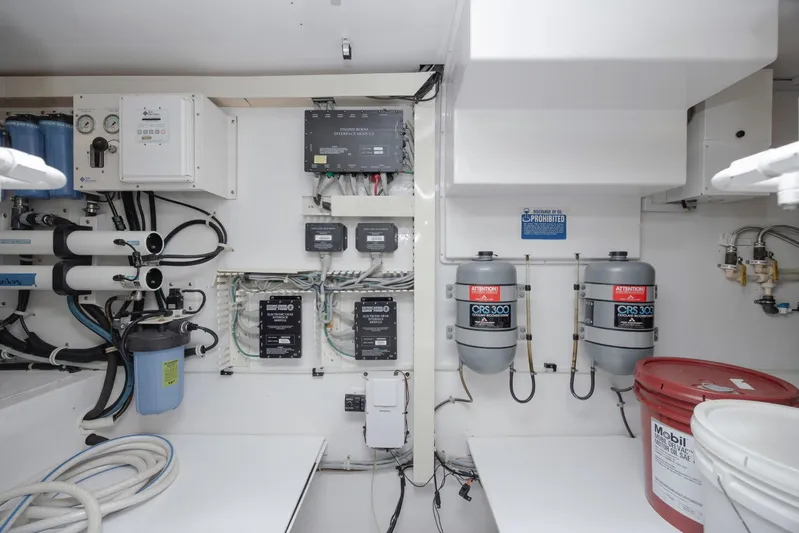 Emeritus Yacht Photos Pics Engine room of 2001 Viking 61 Convertible yacht with filtration systems and control panels.