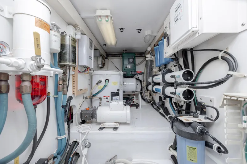 Emeritus Yacht Photos Pics Engine room of 2001 Viking 61 Convertible yacht with various mechanical components.