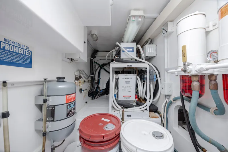 Emeritus Yacht Photos Pics Engine room of 2001 Viking 61 Convertible yacht with equipment and storage barrels.