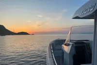 2023 Fjord 38 Open yacht at sunset on calm waters.