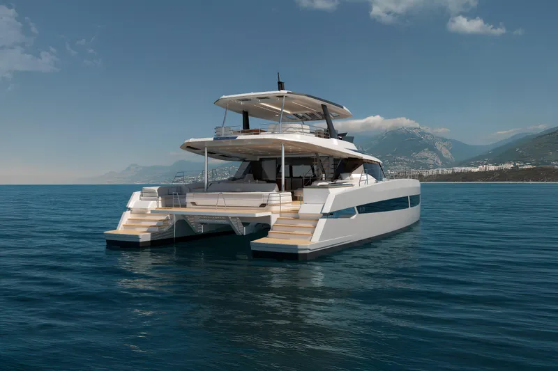 Hull #2 Fpy 70 - Coming End 2026 Yacht Photos Pics Luxurious 2027 Fountaine Pajot FPY 70 catamaran on serene ocean waters, with mountainous backdrop.
