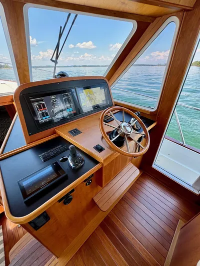 Grand Baby Yacht Photos Pics Legacy 42 boat helm with wooden interior, modern controls, and ocean view.