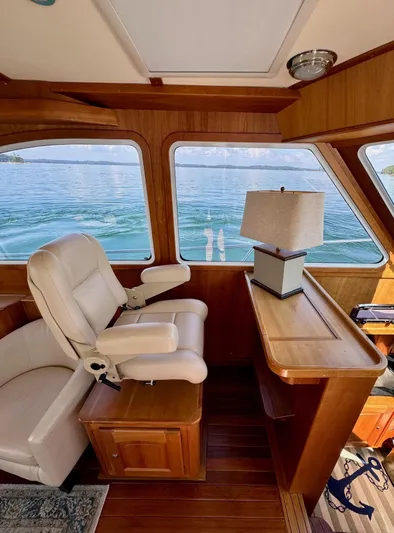 Grand Baby Yacht Photos Pics Interior of 2018 Legacy 42 boat with white captain's chair and wooden accents.