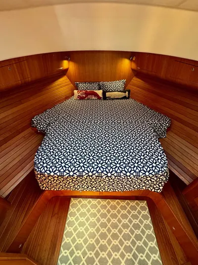 Grand Baby Yacht Photos Pics Cozy cabin interior of 2018 Legacy 42 yacht with patterned bedding and warm lighting.