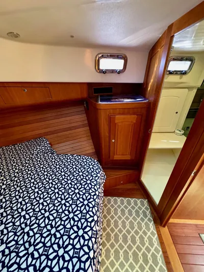 Grand Baby Yacht Photos Pics Cozy cabin interior of 2018 Legacy 42 yacht with patterned bedding and wooden accents.