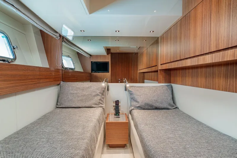 4leon Yacht Photos Pics Luxurious interior of 2026 Navetta Navetta 33 yacht with twin beds and wooden accents.