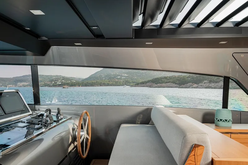 4leon Yacht Photos Pics Interior view of 2026 Navetta Navetta 33 yacht, showcasing helm and scenic ocean backdrop.