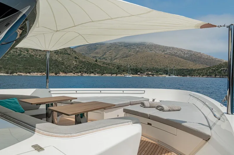 4leon Yacht Photos Pics Luxurious Navetta 33 yacht deck with seating, tables, and scenic ocean view, 2026 model.