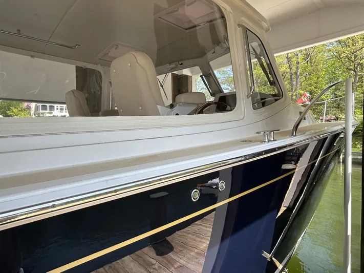 True Grace Yacht Photos Pics 2011 MJM 36Z boat, side view, docked, showcasing sleek design and cabin interior.