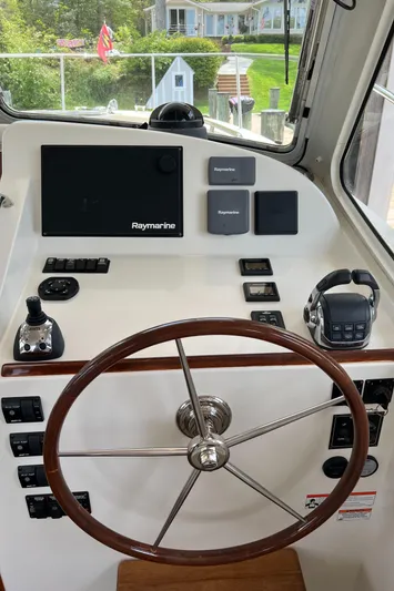 True Grace Yacht Photos Pics 2011 MJM 36Z helm with Raymarine electronics and wooden steering wheel.