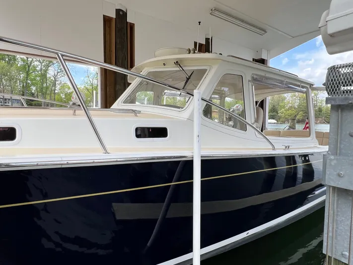 True Grace Yacht Photos Pics 2011 MJM 36Z boat docked in a covered marina, side view.