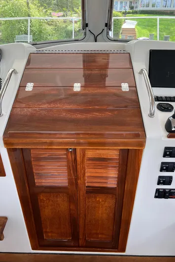 True Grace Yacht Photos Pics 2011 MJM 36Z helm station with wooden cabinetry and control panel.