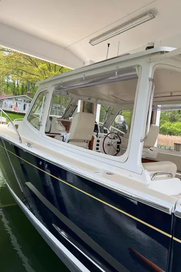 True Grace Yacht Photos Pics 2011 MJM 36Z boat docked under a covered area, showcasing sleek design and modern features.