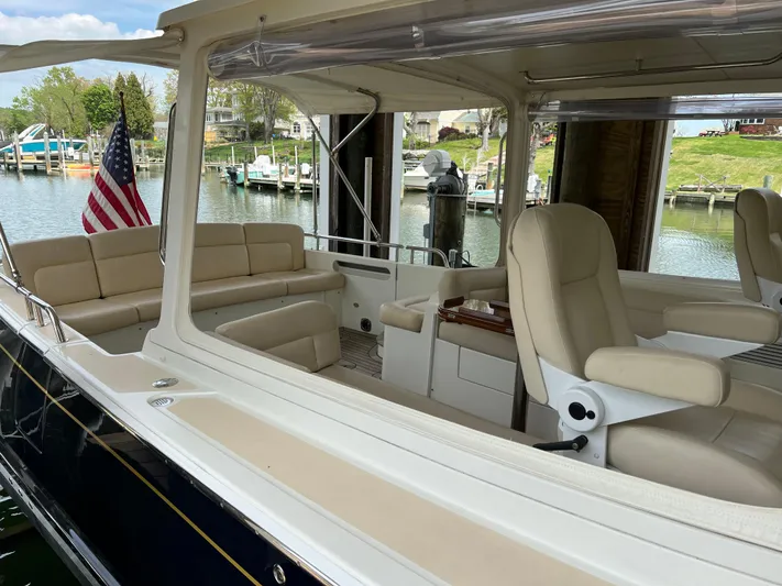 True Grace Yacht Photos Pics 2011 MJM 36Z boat interior with beige seating, docked by a marina.