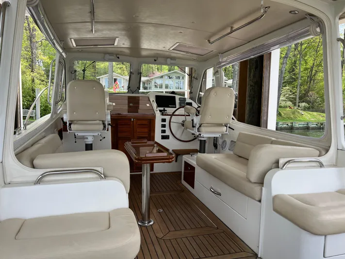 True Grace Yacht Photos Pics Interior of a 2011 MJM 36Z boat with beige seating and wooden accents.