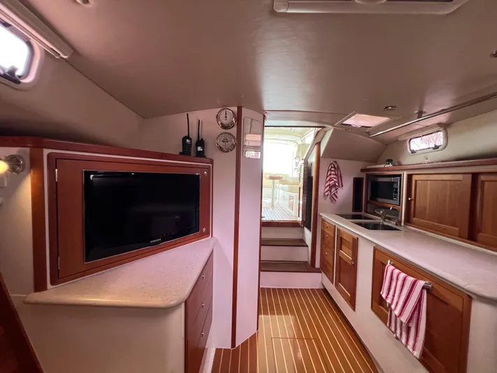 True Grace Yacht Photos Pics Luxurious interior of 2011 MJM 36Z yacht with modern amenities and wooden finishes.