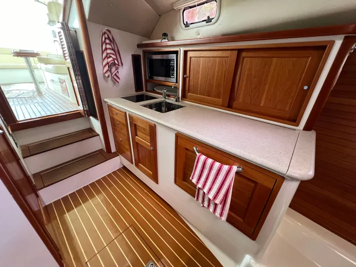 True Grace Yacht Photos Pics 2011 MJM 36Z yacht interior with wooden cabinetry and modern kitchen amenities.