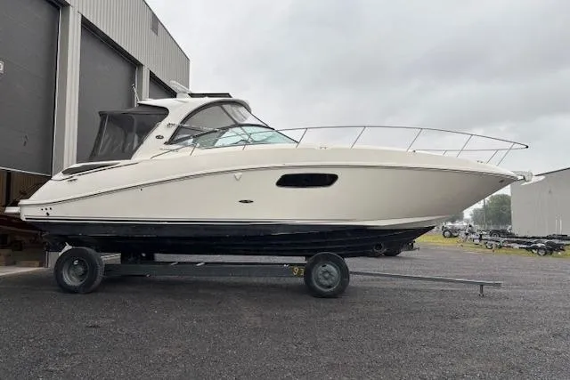 Pura Vida Yacht Photos Pics 2012 Sea Ray 370 Sundancer boat on trailer outside a warehouse.