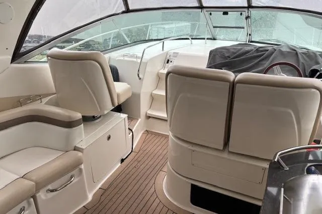 Pura Vida Yacht Photos Pics 2012 Sea Ray 370 Sundancer interior with beige seating and wooden flooring.