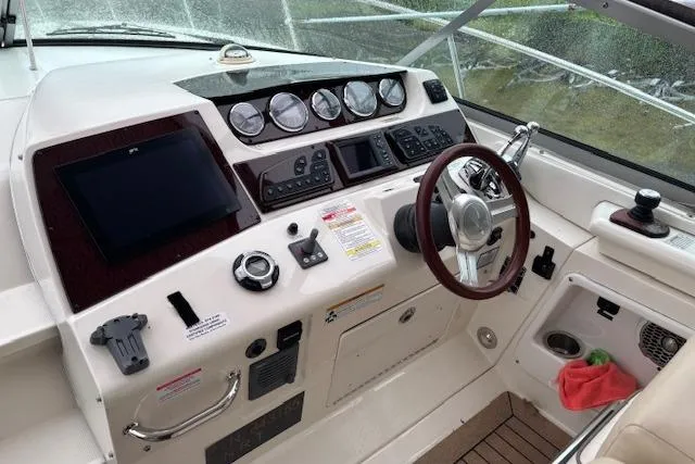 Pura Vida Yacht Photos Pics Cockpit of 2012 Sea Ray 370 Sundancer with steering wheel and control panel.