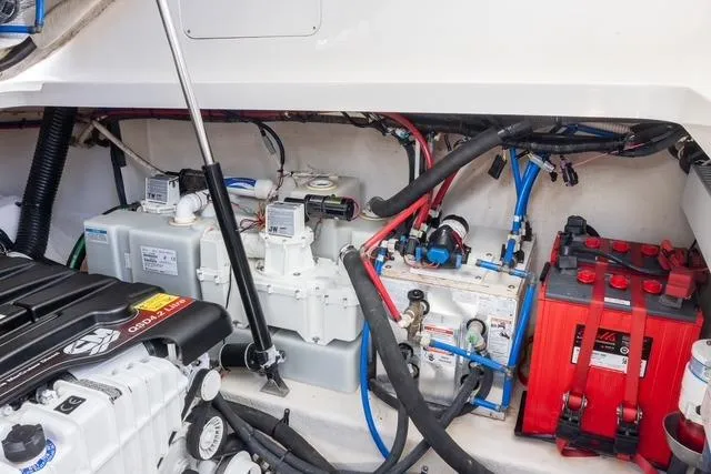 Pura Vida Yacht Photos Pics Engine compartment of 2012 Sea Ray 370 Sundancer, showcasing batteries and mechanical components.