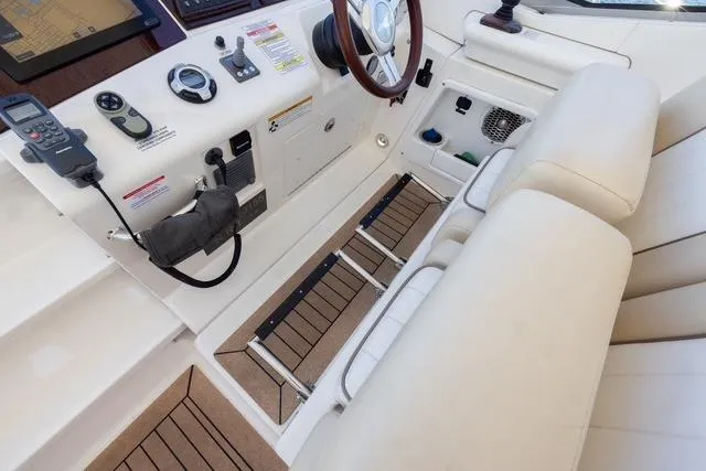 Pura Vida Yacht Photos Pics Interior cockpit of 2012 Sea Ray 370 Sundancer with steering wheel and controls.